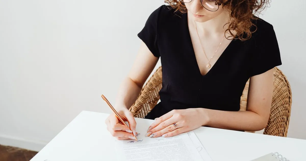 Reviewing and signing a loan application after deciding you need a loan in Canada